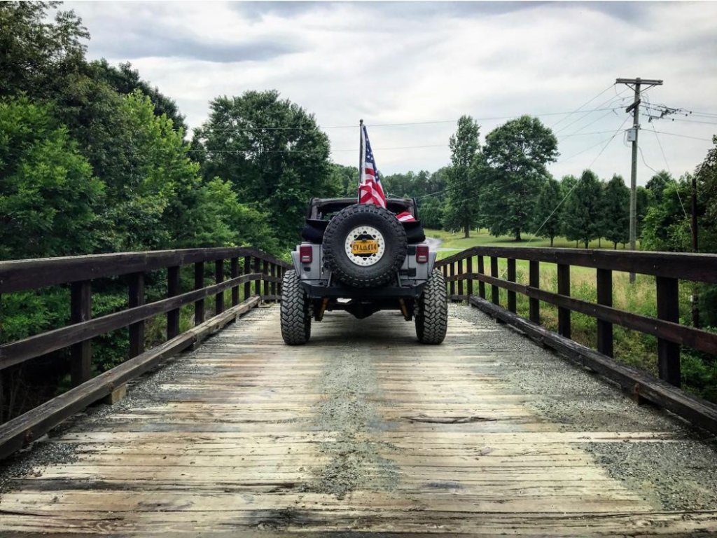Rearview of a 4x4 with an American flag on the back