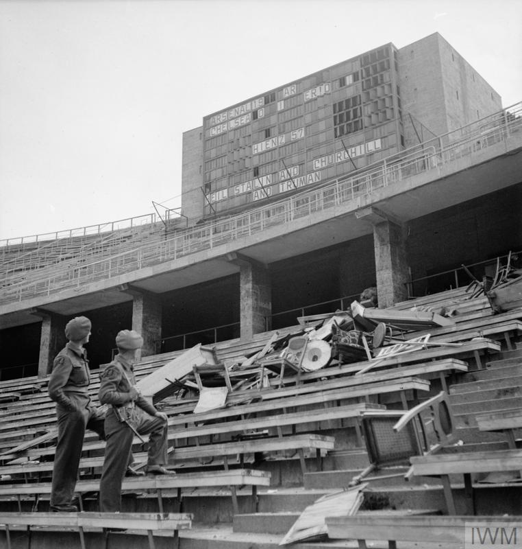 RealTimeWWII's tweet photo. In Berlin, British occupying troops pose next to Olympic Stadium scoreboard set up by unknown satirist: "Heil Stalin & Churchill & Truman." https://t.co/5NCIYXkwtw