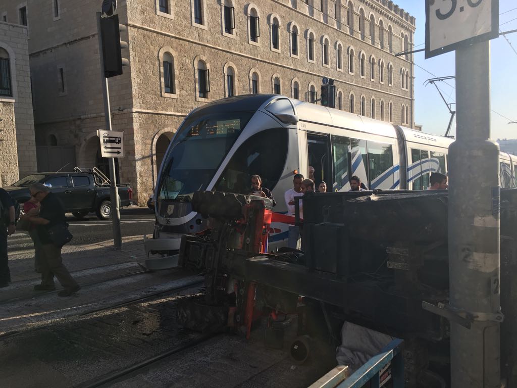 IsraelHatzolah's tweet photo. JERUSALEM: Driver of garbage truck lightly injured in an accident involving the light railway train on Bar Lev St - PHOTO. https://t.co/vGAdCm26IJ