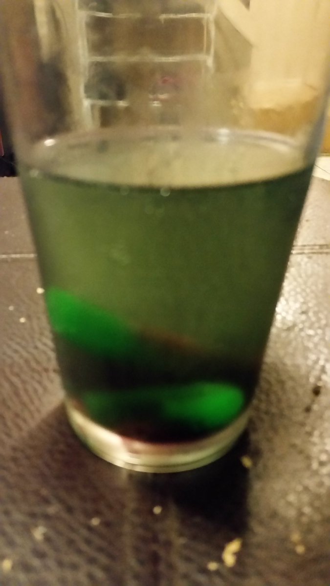 TanyaLGauthier's tweet photo. This may look poisonous, but it's just a jolly rancher popsicle in a glass of Zimas. #writerslife #weirddrinks https://t.co/OBSNRhNrMQ