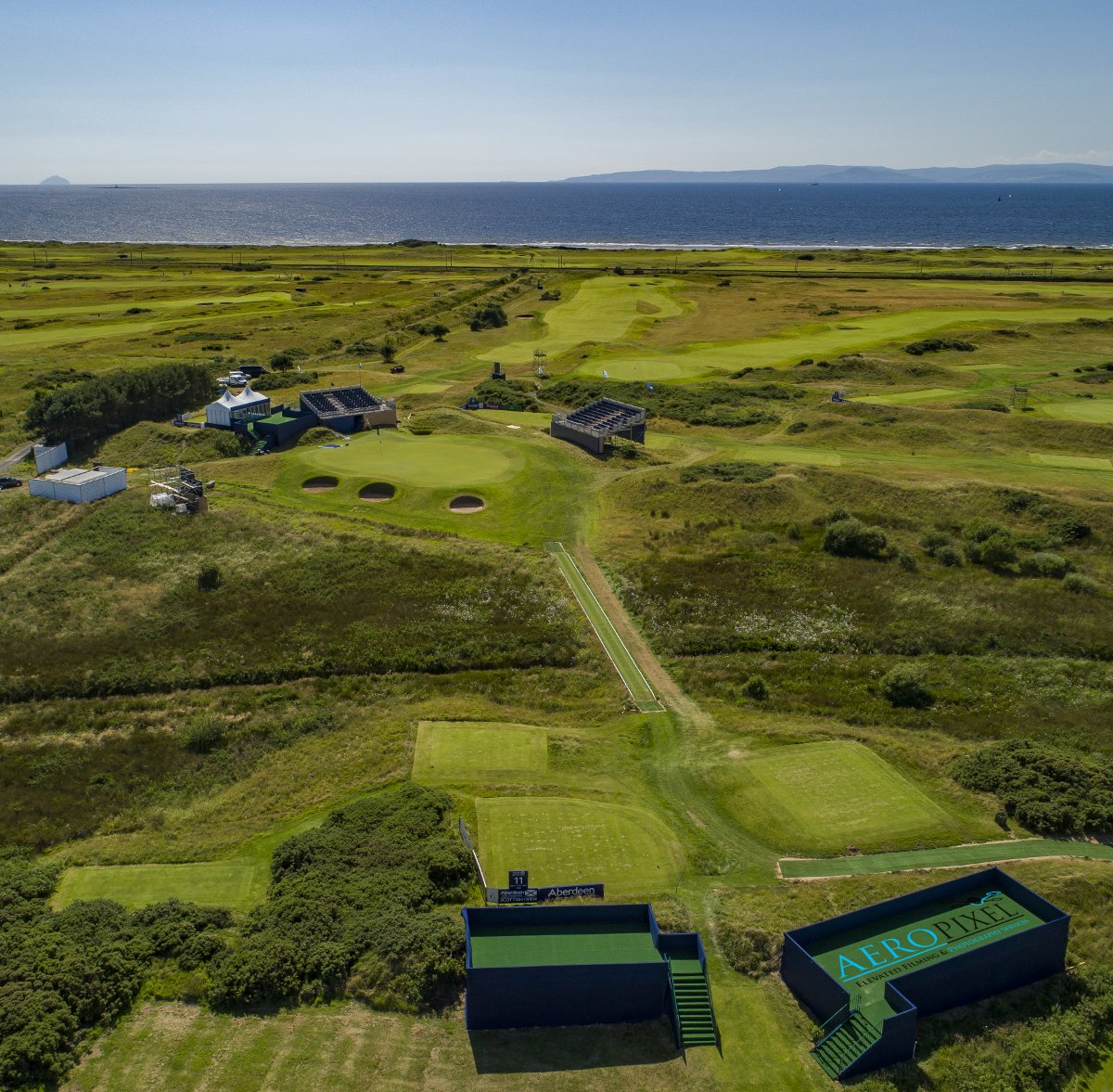 AeroPixScotland's tweet photo. The par 3 11th @DundonaldLinks answer to the 'postage stamp' all dressed up for this weeks #Scottishopen @AAMScottishOpen #AeroPixScotland https://t.co/Krpy7vZRZZ