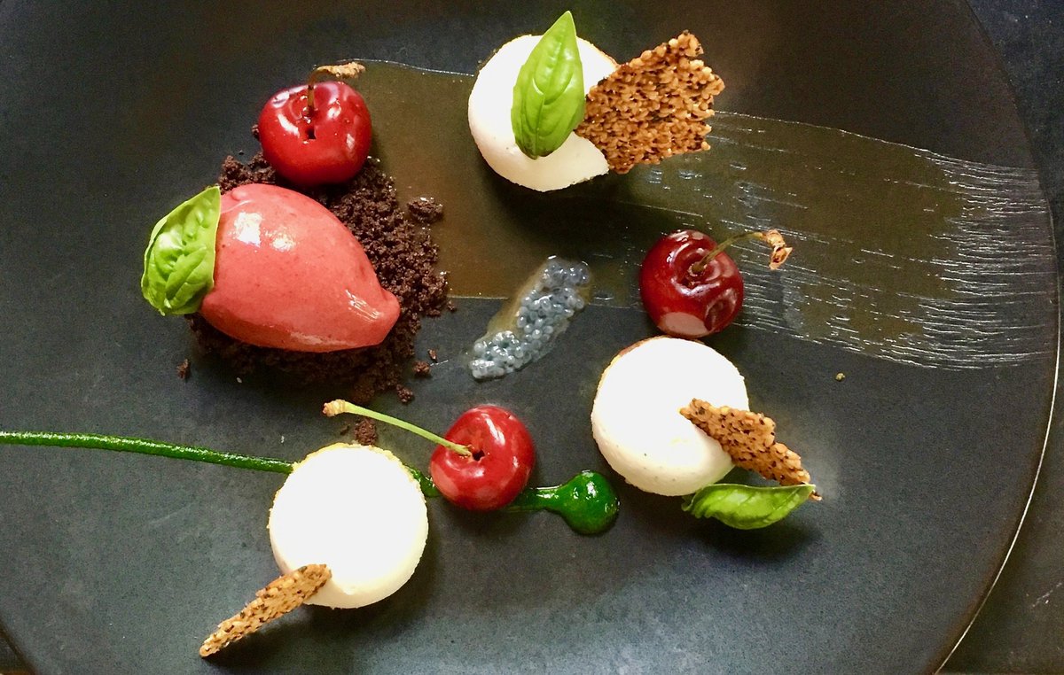 Sheep’s milk ricotta cheesecake, tart cherry sorbet, sweet basil puree, sesame-cherry cake, caramel, and seeded tuile by <a href="/northpondbruce/">Bruce Sherman</a>.