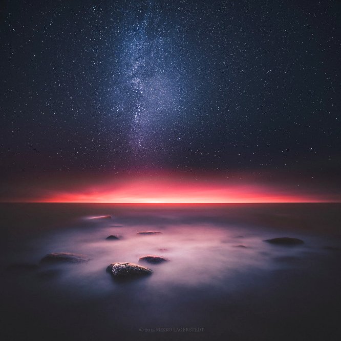 Good evening, "The Whole Universe Surrenders" by Mikko Lagerstedt. #nightphotography #seascape #astrophotography #shore #red #sea #ocean