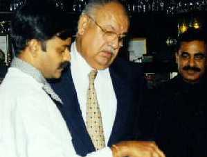 Naresh Chandra interacting with a younger man at an official event in 2017.