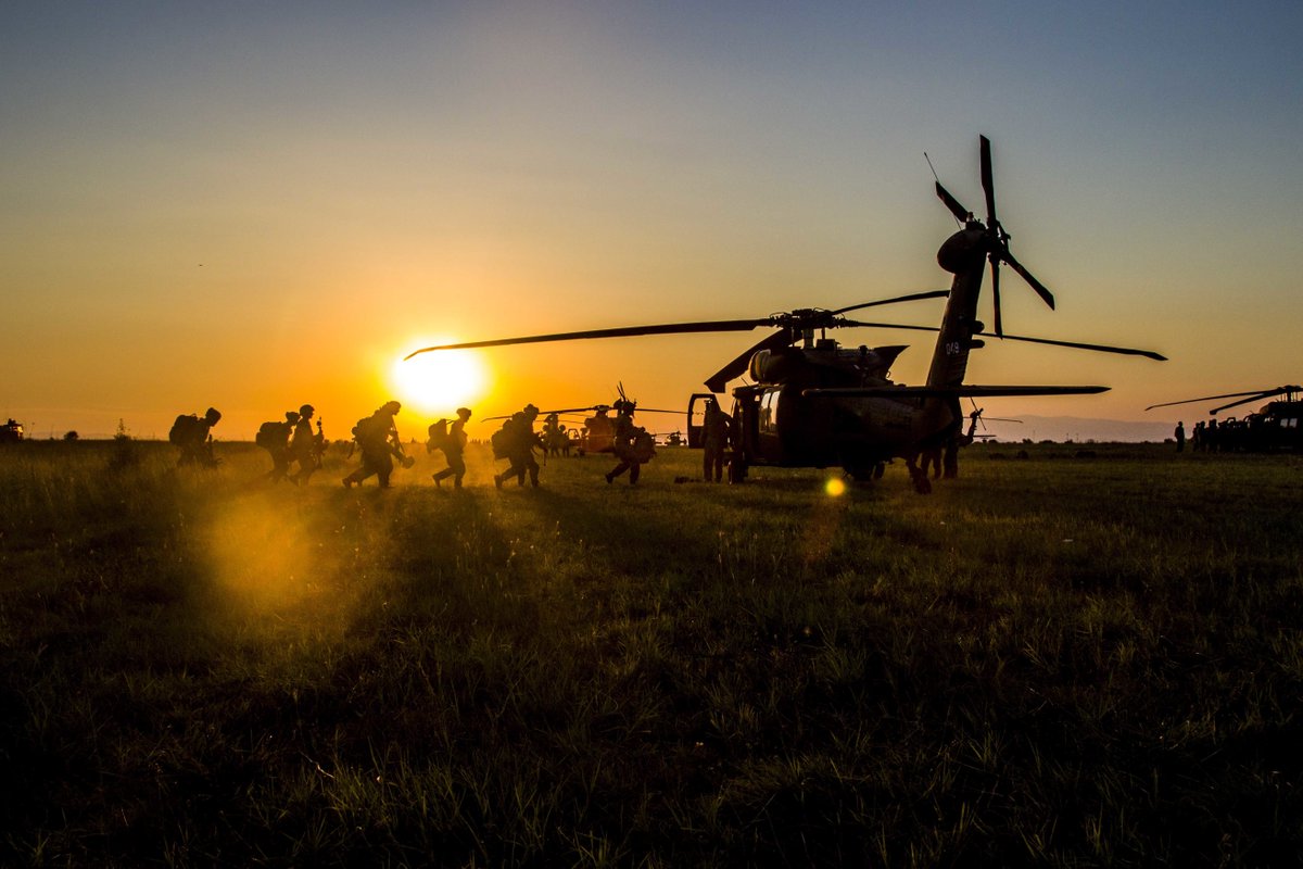 DeptofWar's tweet photo. By the light of the ☀. @USArmy infantrymen practice loading into a #BlackHawk 🚁 in #Bulgaria during #SwiftResponse. #SaberGuardian https://t.co/WsS9eegTTn