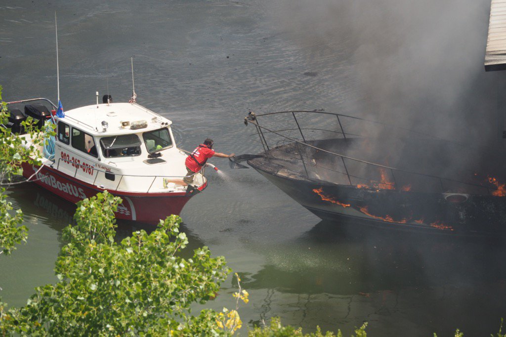 cjenningshd's tweet photo. A firefighter pushes a boat that broke loose back into its slip. https://t.co/qvCH6ibFFi