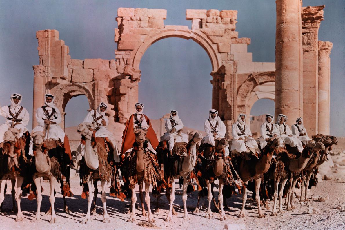 syria_throwback's tweet photo. Syrians perched atop camels prepare to ride in front of the gateway at Palmyra in the 1930s.
Photograph by: W. Robert Moore https://t.co/AB1SrhoW2P