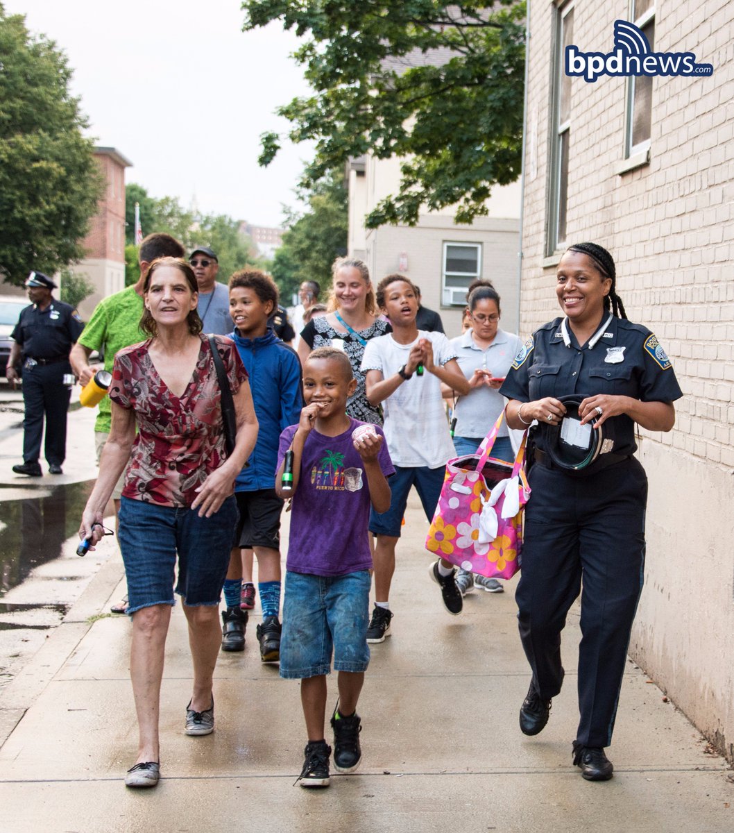 bostonpolice's tweet photo. #FlashlightWalks are more fun after a little shower in Southie! Our officers had a great time with all the folks that turned out! https://t.co/YbWaCCcJD8
