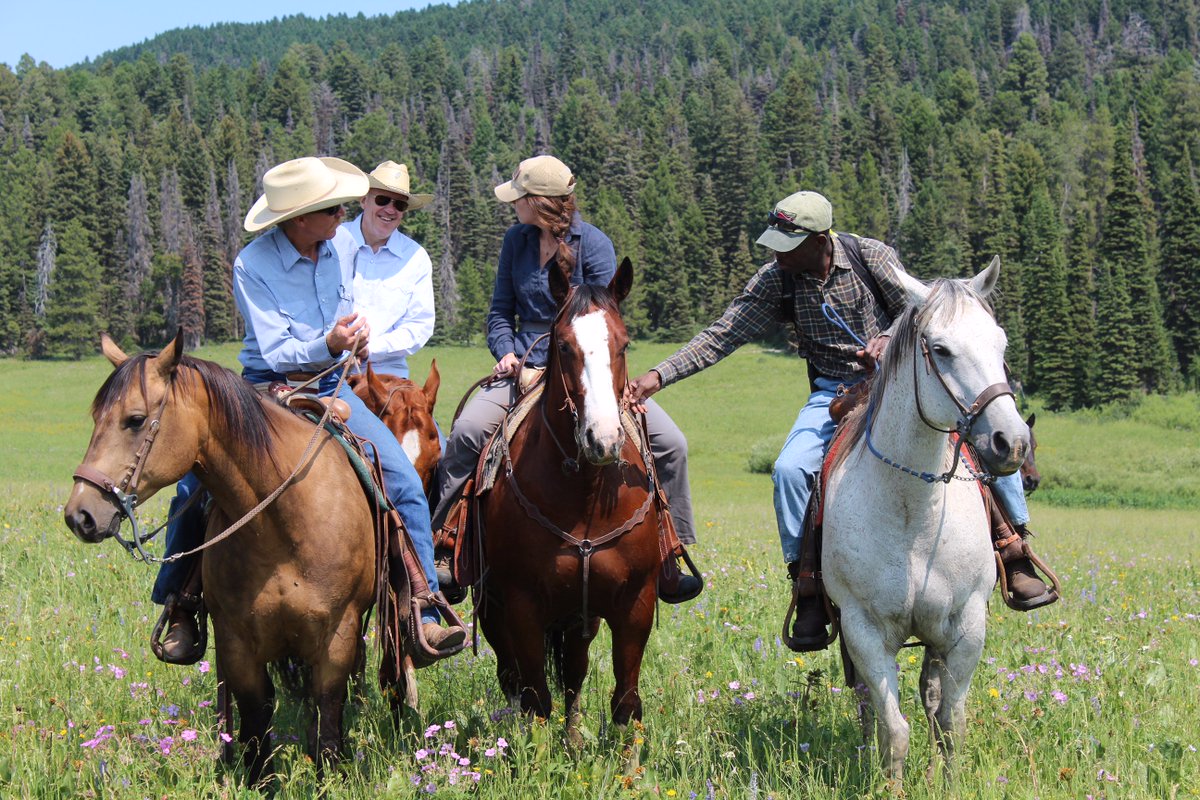 SecretaryZinke's tweet photo. Another meeting in the "office" -
 Acting Assistant Secretary Kate &amp; Acting @BLMNational Director Mike hit the trails with #Idaho ranchers. https://t.co/RgfU9VFNQj