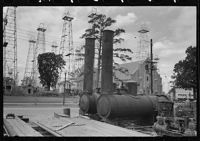 EnergyWeldfab's tweet photo. From the @librarycongress Prints & Photographs Division: "#Oil well boilers with church & #oilderricks in the background." #KilgoreTX https://t.co/tXCl3Zna6L