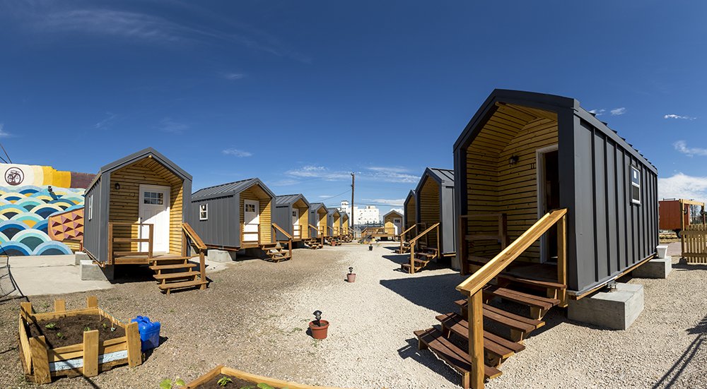 Denverite's tweet photo. It’s officially move-in day for Denver’s tiny home village for the homeless https://t.co/4dAg1lXRvl https://t.co/HUJsKYdMhS