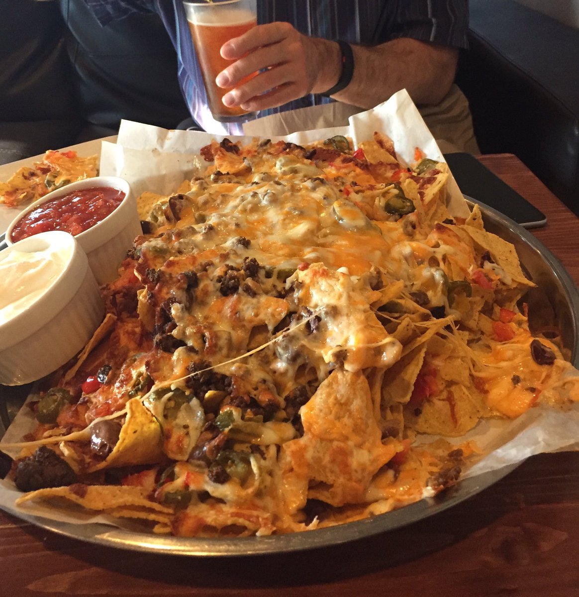 GarthGerwing's tweet photo. So my buddy and I were in @boulevardPB and ordered the nachos. We were warned they were big...yeah, whatever. Got humbled #Charleswood https://t.co/r4CSuCQyqk