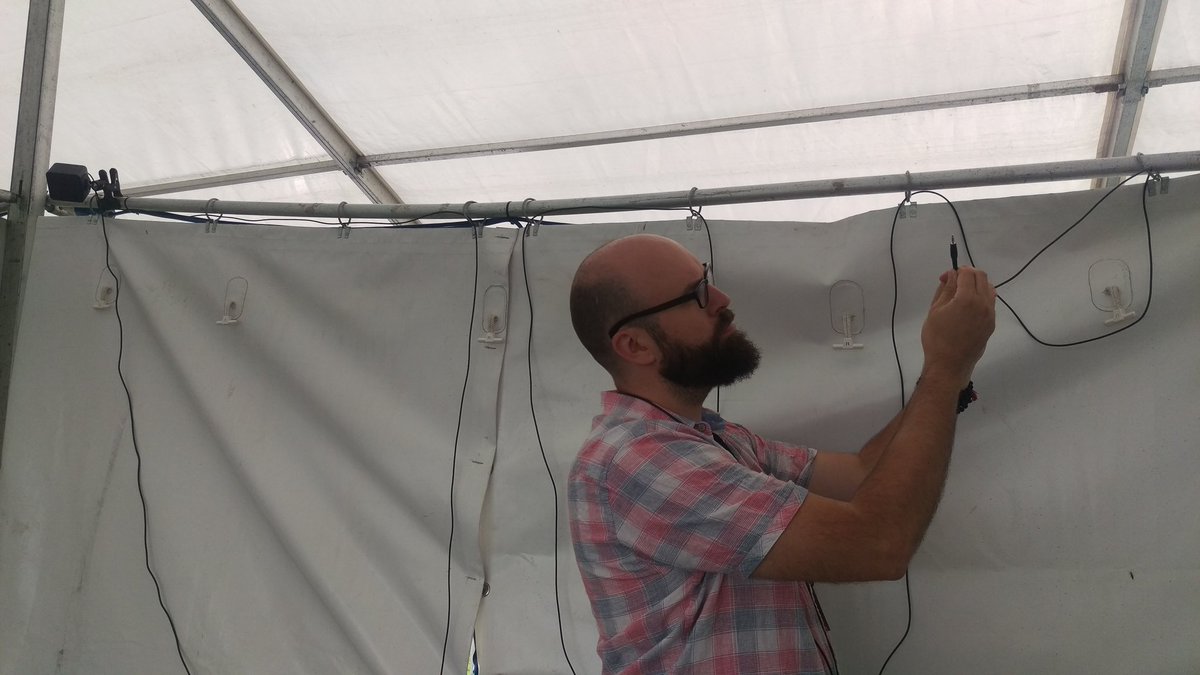alphachar's tweet photo. Owen wiring up the booth and pontificating: "A true VR professional always goes wired."
#exploredeep #DublinMaker https://t.co/6SmqR6O9yE