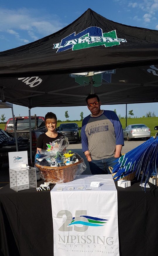 NipissingU's tweet photo. Come down to the North Bay Farmers Market and say hi to Casey &amp; Kate. Grab some free Lakers swag and help celebrate our 25th anniversary! 💙💚 https://t.co/YwRqNOPw4Z