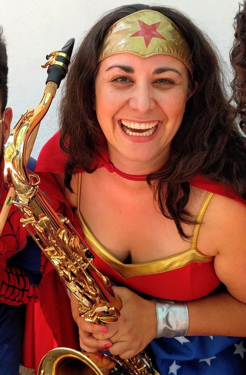 Hey <a href="/sdutIdeas/">Find us now at @sdutOpinion!</a> check out our Wonder Woman Stefanie Schmitz on the sax! She's playing music downtown at Comic Con all week!