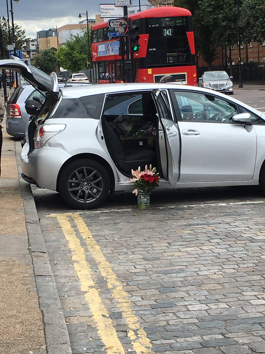 Just walked by (presumably) the family of Rashan Charles collecting the flowers left at the spot he was arrested. Tragic