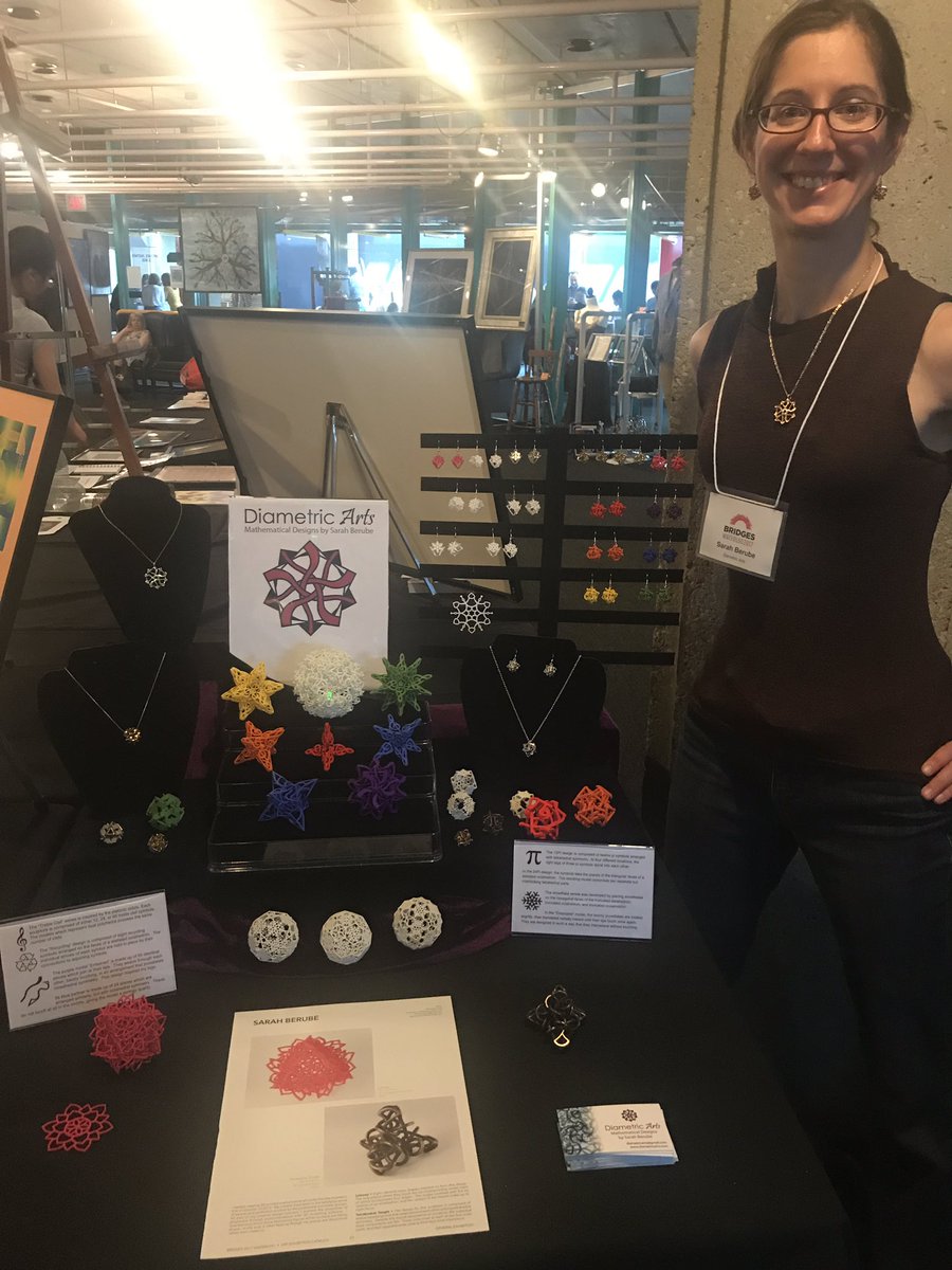 baabbaash's tweet photo. Sarah Berube of @DiametricArts in front of her award-winning display of gorgeous mathematical designs at #BridgesMathArt2017 https://t.co/E38c76Ed0B