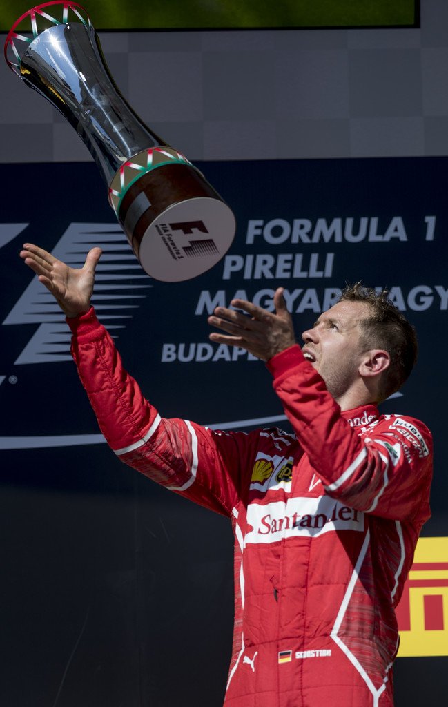 sebvettelnews's tweet photo. Sebastian Vettel with his trophy on the podium 😊🏆

#HungarianGP 🇭🇺 #F1 #Seb5 https://t.co/2xcx87XuvH