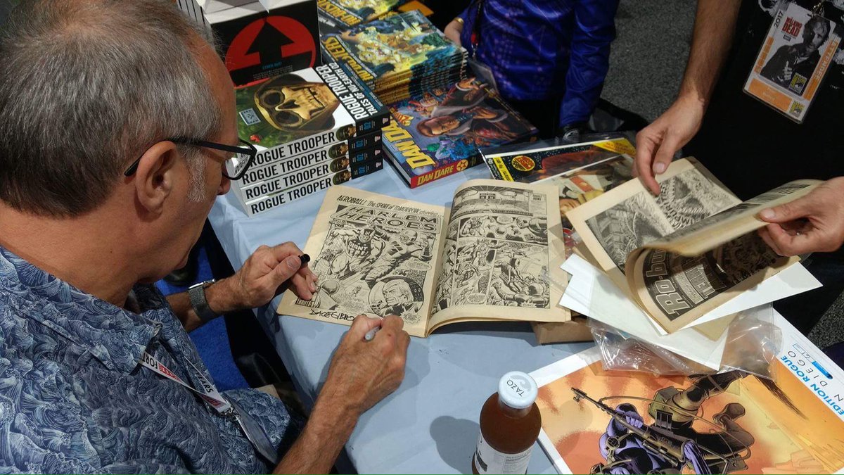 2000AD's tweet image. Forty years on, @davegibbons90 signs a copy of 2000 AD Prog One at #SDCC17