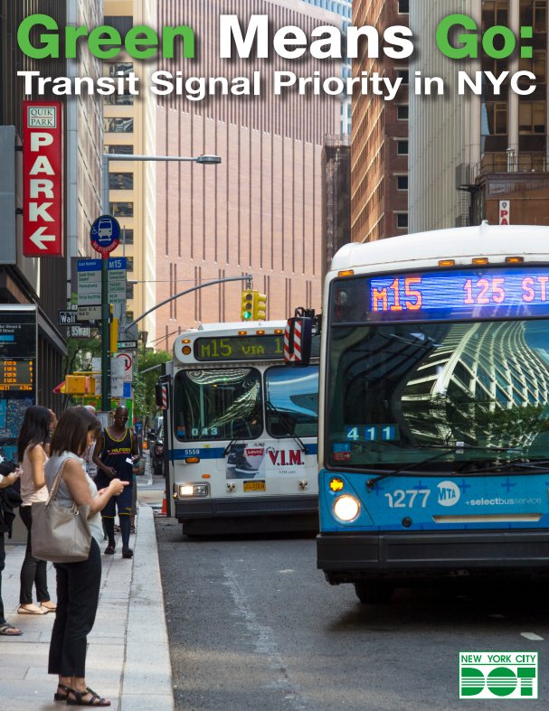 Photo of two buses traveling through a signalized intersection with a green light, as the buses approach a bus stop with people ready to board the buses