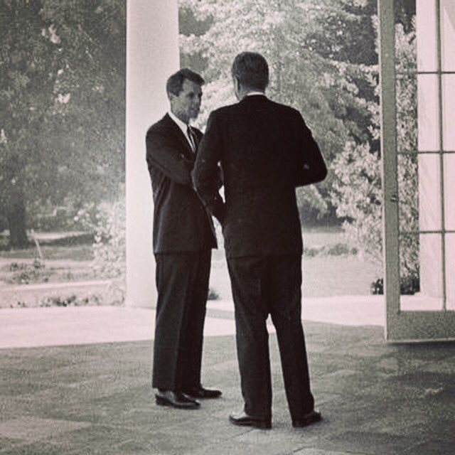 RFKquote's tweet photo. #RFK & #JFK conferring outside the #OvalOffice. #RFKphoto #IconicPhotograph #whitehouse #kennedy #photography #history https://t.co/bg0Na3HE07