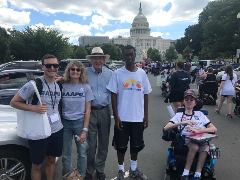 AAPD staff and intern pose for a photo with Senator Harkin with the US Capitol Building in the background.