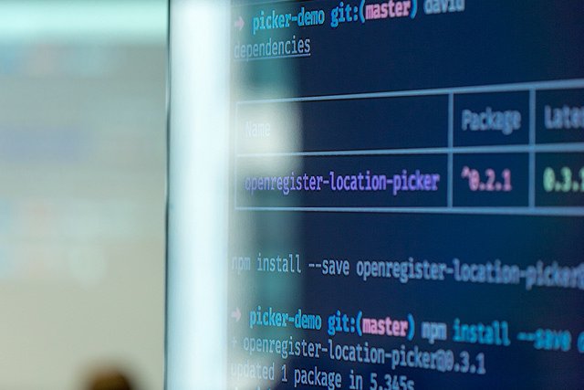 Photograph of a monitor screen with data code running on it