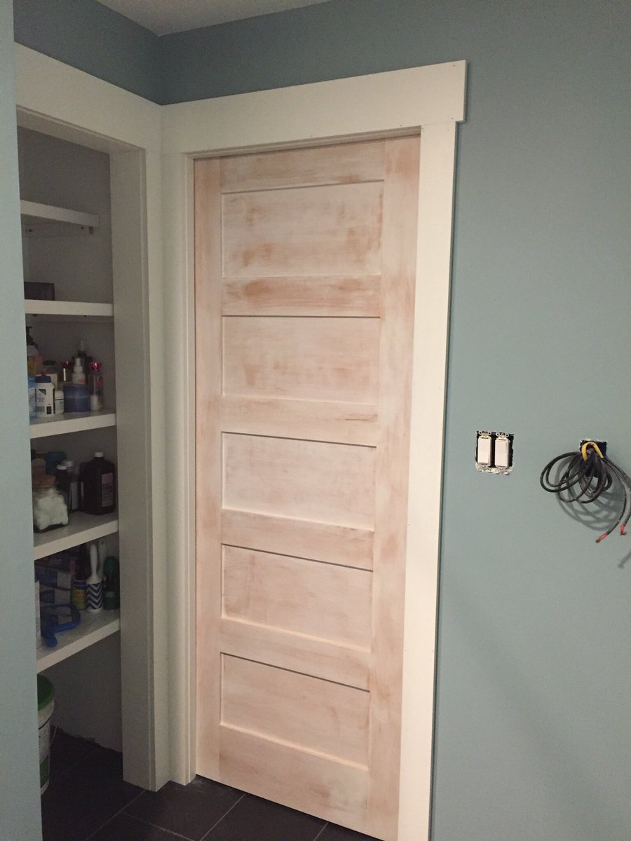 A custom maple wood pocket door with a white wash, one more needed for the closet.