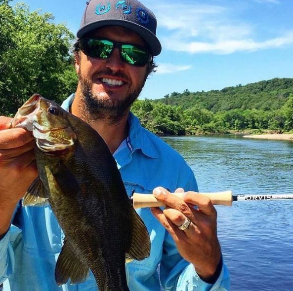 ShootingSociety's tweet photo. .@LukeBryanOnline testing out the #Helios3 rod and landing a small mouth bass. RSVP kathryn@zambuni to try it out @TheGameFair this weekend! https://t.co/SfV6YNUC0o