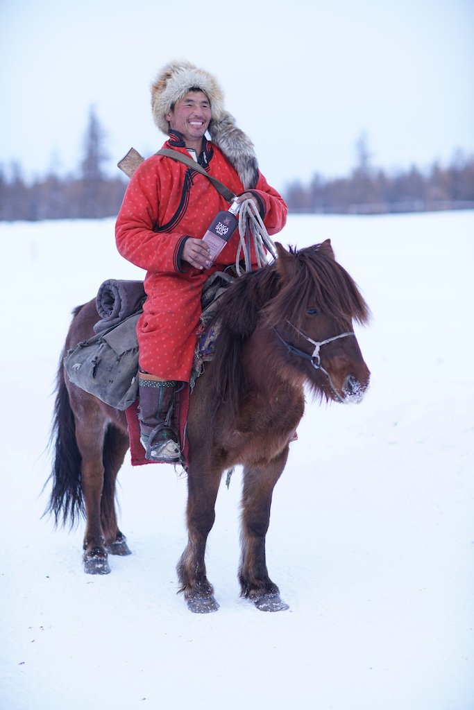 TaigaShtof's tweet photo. A local horse herdsman in Buryatia enjoying a bottle of Taiga Shtof. #vodka #spirits https://t.co/IqyEqewXGK