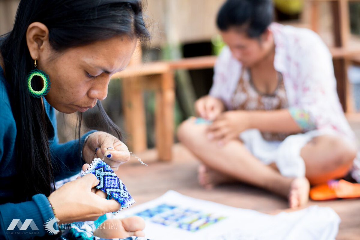 Women making jewelry are part of the Women's Cooperative of Mutum indigenouscelebration.org/impact/
