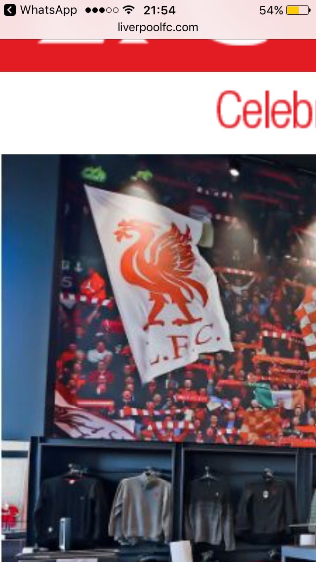 johnhopwood1's tweet image. Pic with my lads flag on the wall in the new shop, pity even with all 19 games on his card he couldn't get Kop tickets to keep it flying !!