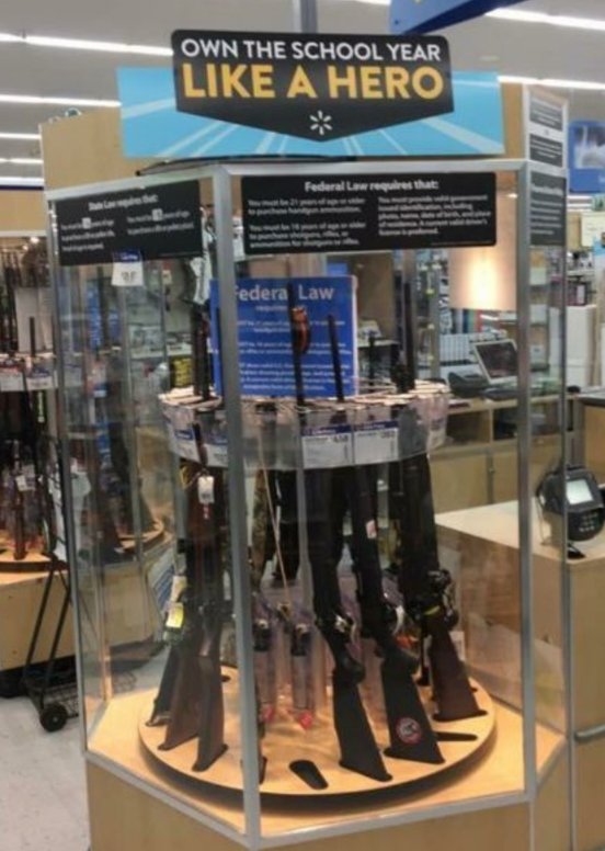 Complex's tweet photo. Walmart apologizes for "own the school year like a hero" signage over gun display: https://t.co/FvneAuTd2b https://t.co/vqOB6PWLnQ