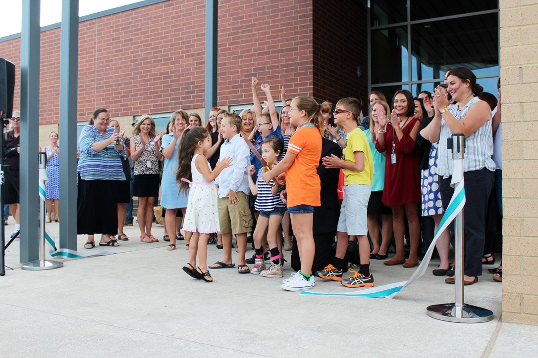 Reunion Elementary students who helped with the school’s ribbon cutting Wednesday celebrate after the ribbon falls. localcolormag.com/images/DailyPo…