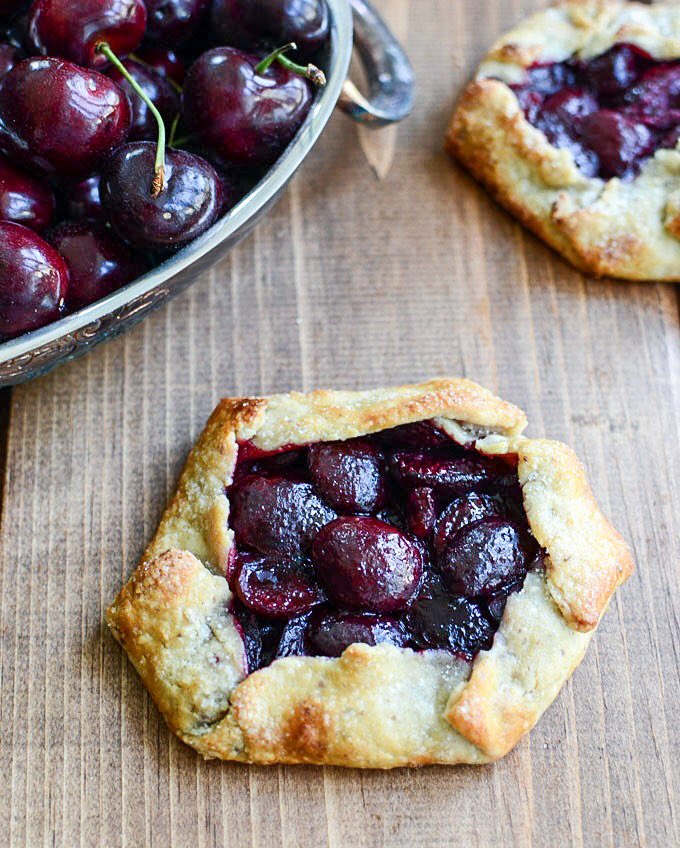 Mini #Cherry Galettes with Almond Sour Cream Crust #desserts #Recipes #cherries thewellflouredkitchen.com/2014/07/29/che…