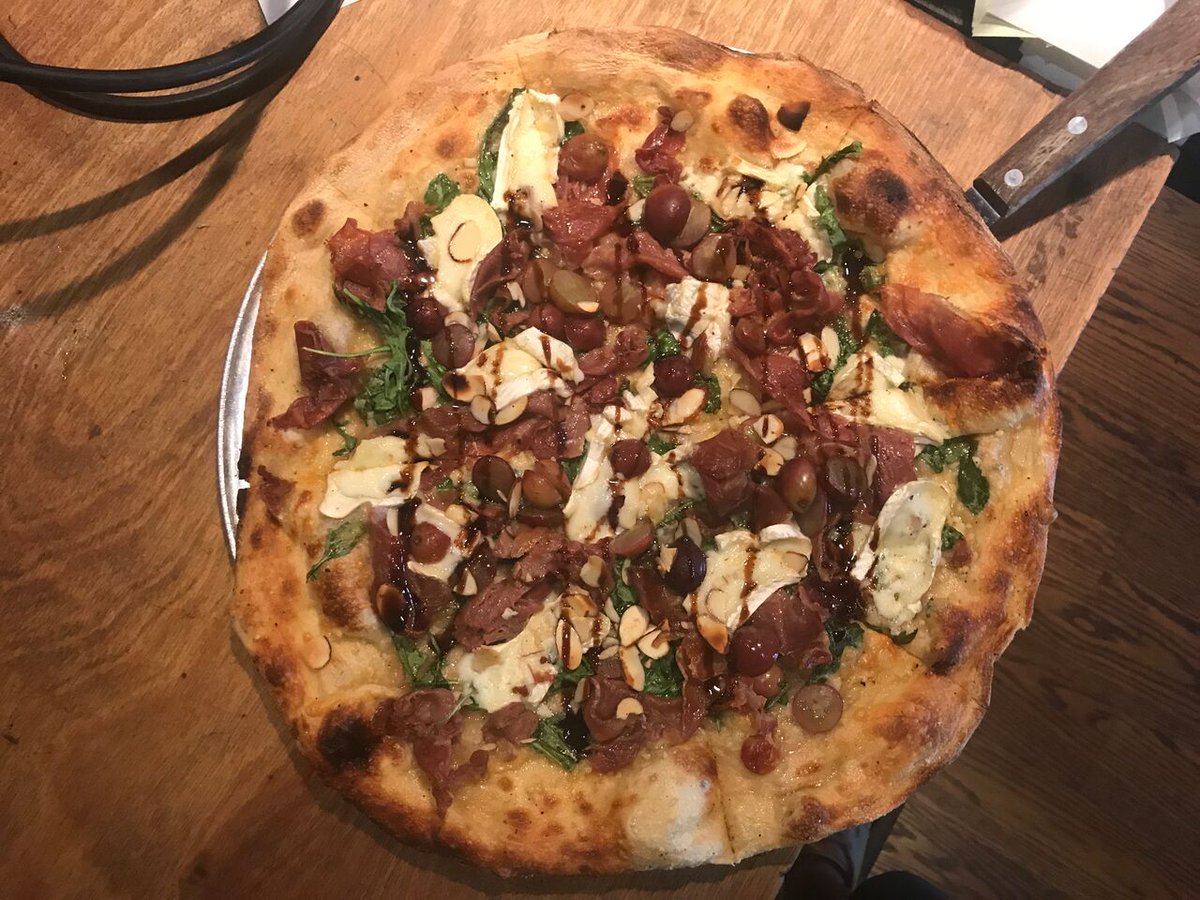 This is sure to BRIE-ten up your day! Garlic infused oil with speck ham, Brie, red grapes, arugula &amp; almonds finished with a Balsamic glaze.