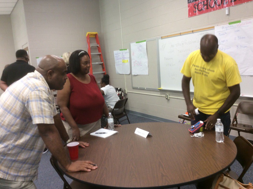 Ben Arrington &amp; Laikhe Green listen to Franklin County Schools teacher explain  phone design -Project-Based Learning