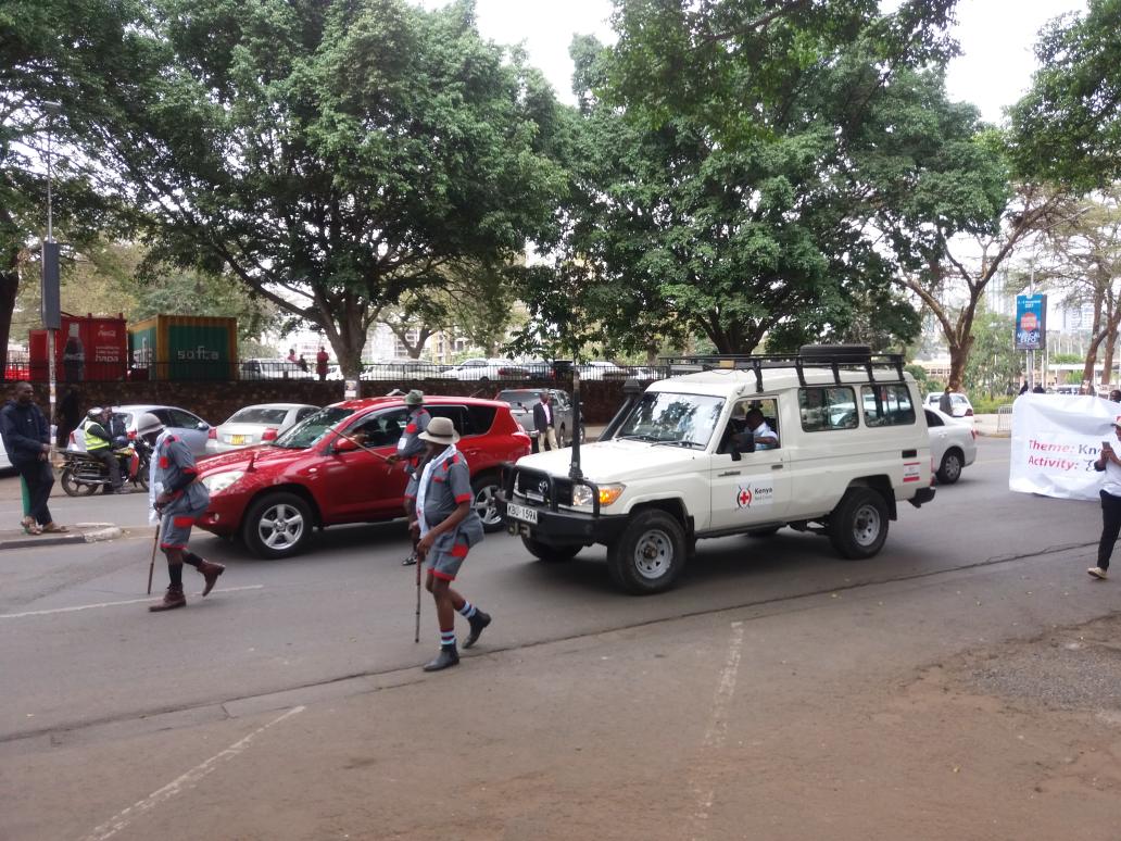 Kriscalf's tweet photo. @KenyaRedCross Theater Team &amp; Land Cruiser - 'Rescue 1" leading the #RedCrossEmblem awareness day procession on #CityHallWay. https://t.co/pGqZu9u3VK