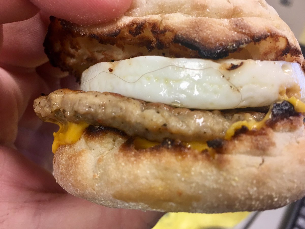 HeroineUniverse's tweet photo. When you take a breakfast sandwich from McDonalds out the wrapper & first thing you see is a DISGUSTING hair on it. #RightInTheTrash #Gross https://t.co/HuHf0PZwX6