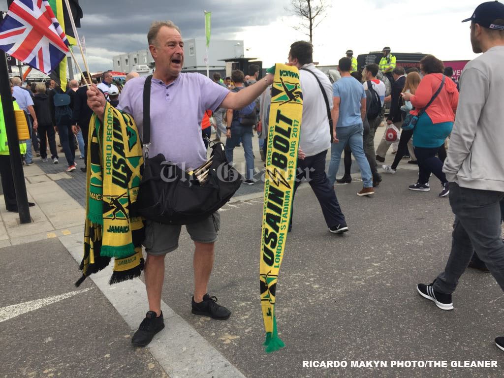 JamaicaGleaner's tweet photo. A man sells Usain Bolt scarfs at the Westfield shopping centre to person heading to the Stadium. #OneLastBolt https://t.co/R3JKMJph6S