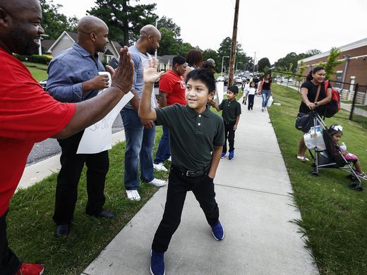 KeeganNYC's tweet photo. African American church lines street w/"Immigrants are Welcome Here" signs to support kids afraid to go to school: https://t.co/4thwEAprAX https://t.co/PqIjiWL1MN