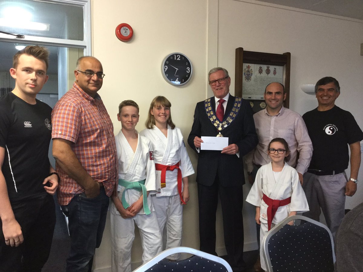 Seaton Town Council Mayor, Cllr Rowland presenting a grant cheque to the Seaton Martial Arts Centre for £500.