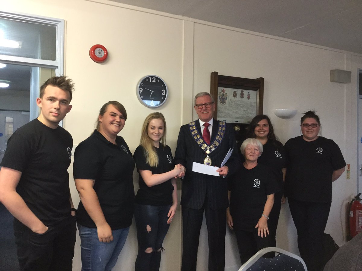 Seaton Town Council Mayor, Cllr Rowland presenting a grant cheque to the Testudo Musical Players for £500.