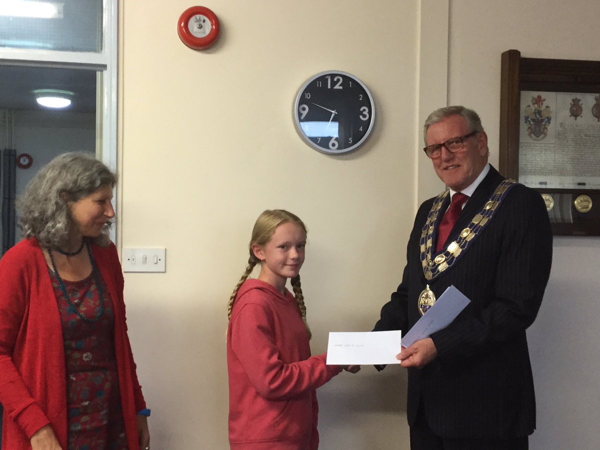 Seaton Town Council Mayor, Cllr Rowland presenting a grant cheque to Seaton Library Teenage Drop In project for £500.
