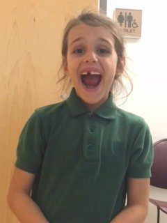 Nursing is the gentle art of caring ... and pulling a 1st Grader's tooth!  Thanks, Mrs. Hankins, for caring for our students.
