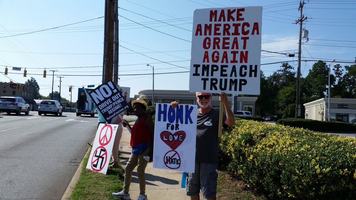 IndivisibleGCo's tweet photo. #TuesdaywithoutTillis with #IndivisibleHighPoint.  Lots of haters today for an anti hate rally.  Super hot out but we persisted. https://t.co/NnXTXaf8Y4