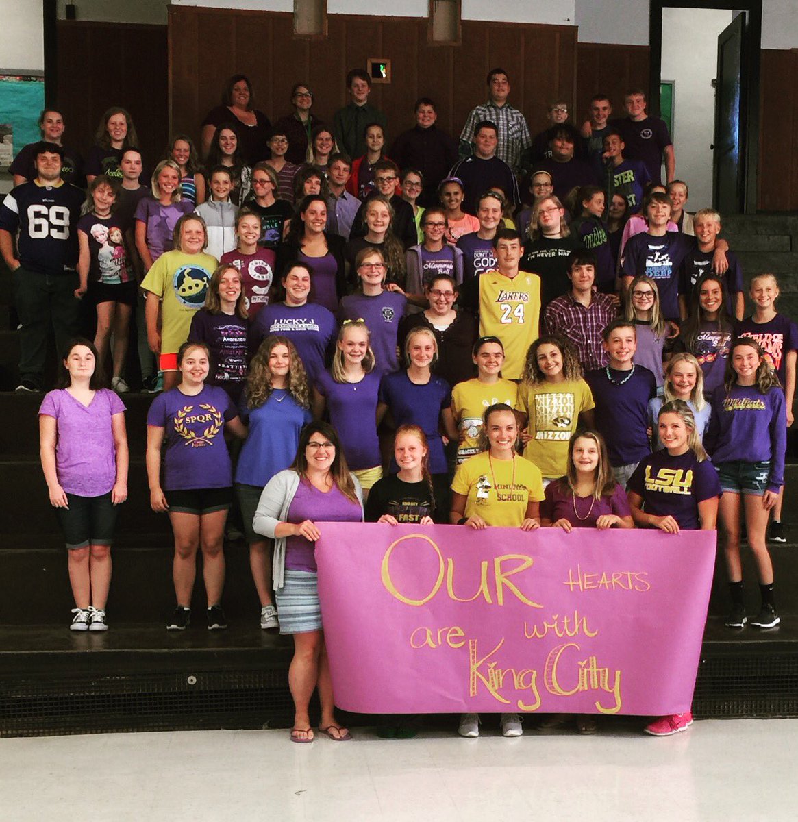 DrBarmannSmith's tweet photo. Students stood in support of our friends in King City today by wearing purple and gold. Our hearts are with King City. 💚💜💛 https://t.co/p0Hng86027