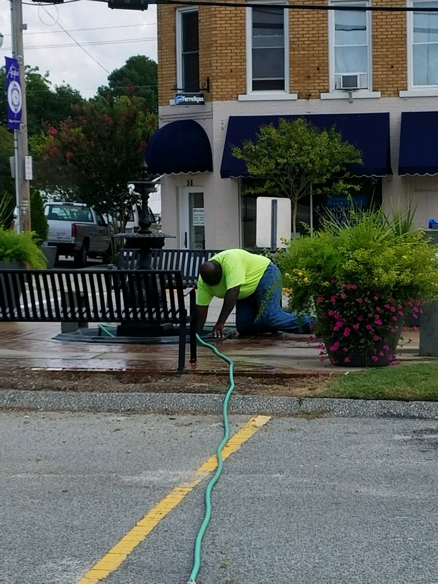 Town Staff cleaning the fountain out in front of Town Hall. #Friday #angier #staff #townhall