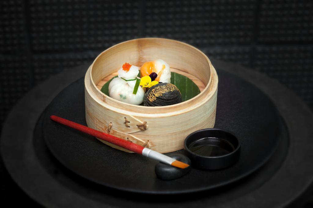 The Da Shu dim sum trilogy, with scallop and white asparagus, sweet langoustine and bamboo shoot dumpling, and chicken and foie gras