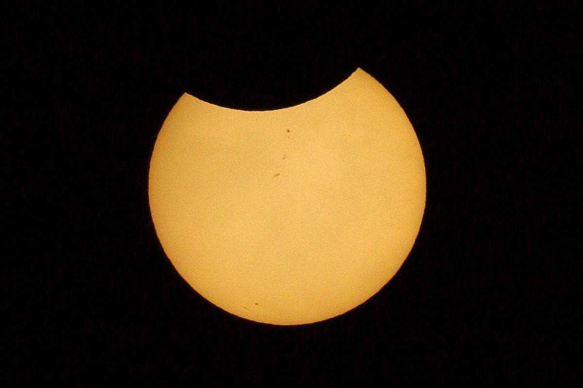 Moon covering small portion of the sun